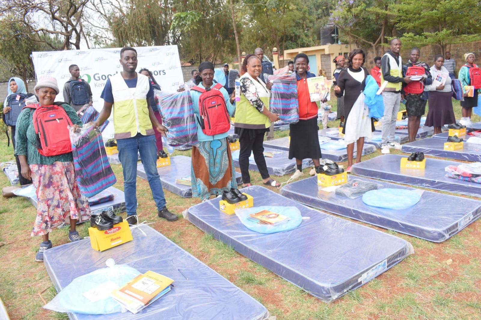 Families in Mukuru receiving school bags, mattresses, and blankets
