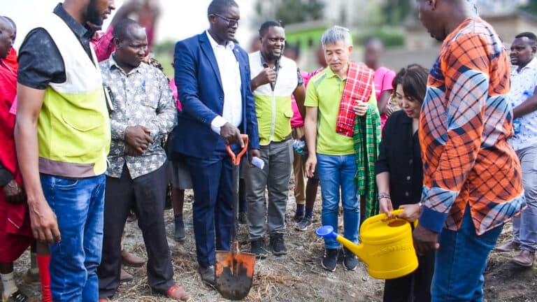 Guests planting a tree at a community project launch
